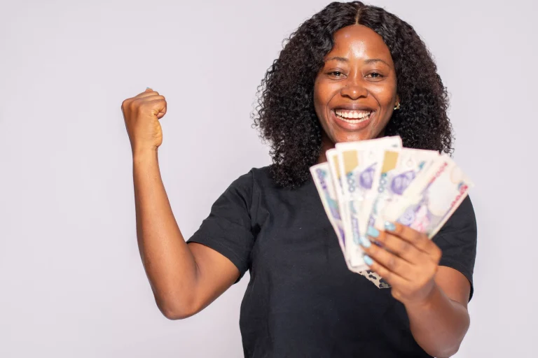 woman with money smilling
