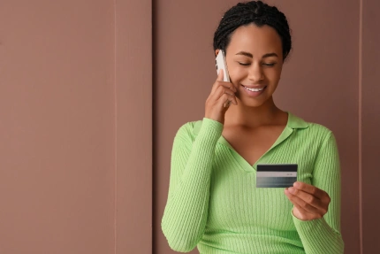 woman holding your credit card talking to the phone